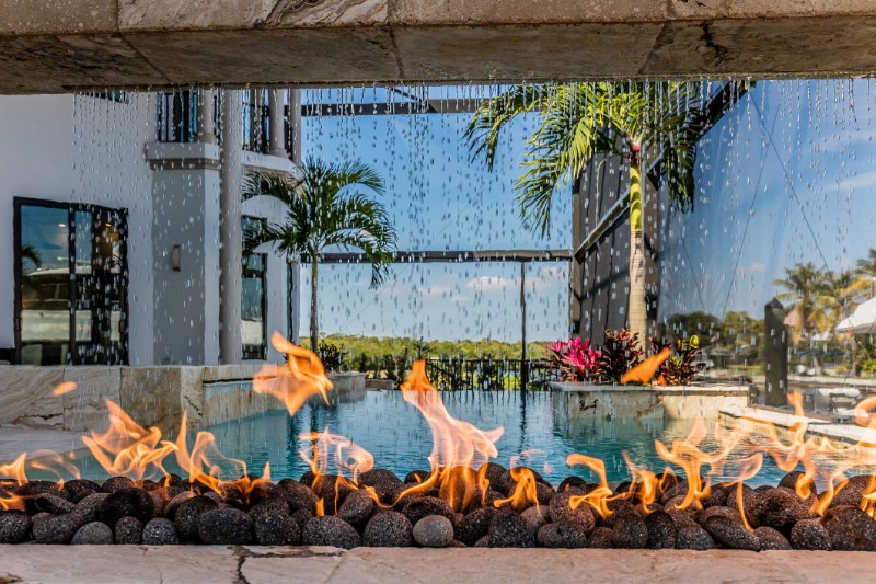 a sophisticated stone wall with poolside fire