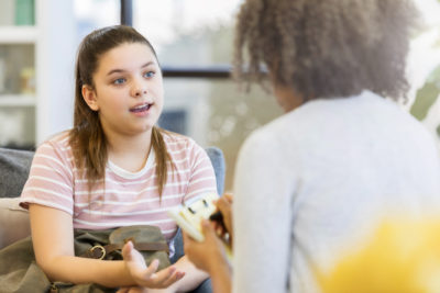 A Teenage Girl Student Talking to a School Counselor about Mental Health