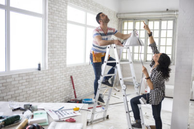 A couple renovating their apartment to raise its home resale value