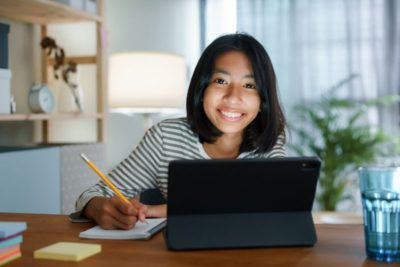homeschooling asian girl doing homework and study online with tablet