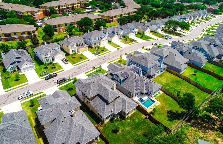 Current aerial view of properties in a neighborhood