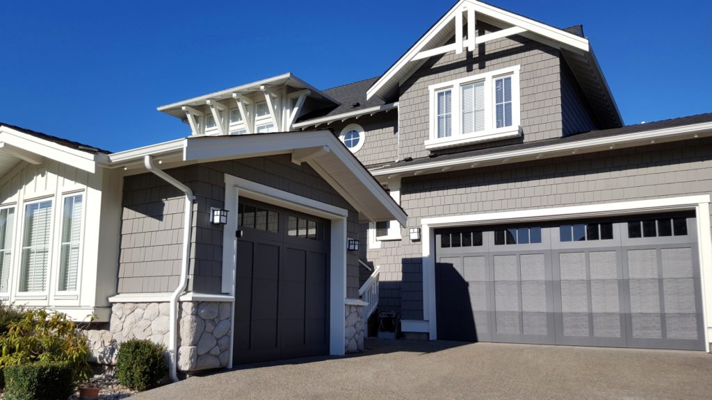 Shingle Style Home With Double And Single Car Garage