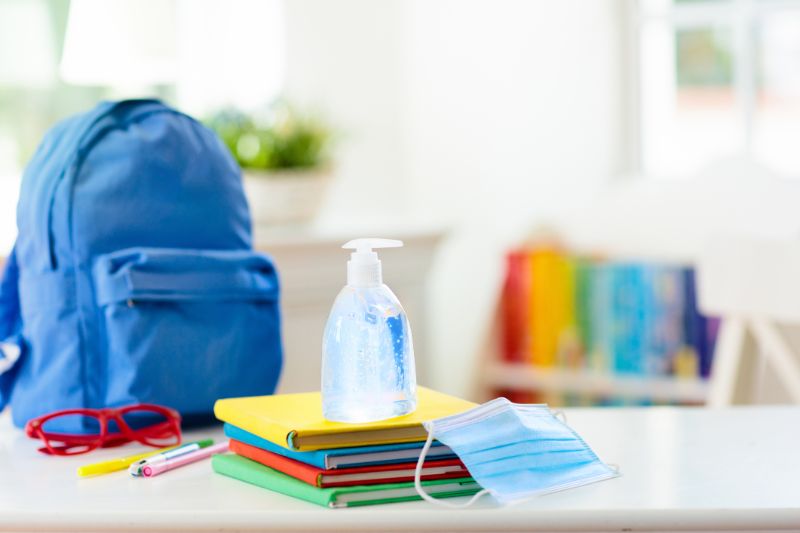 backpack of school child face mask and sanitizer