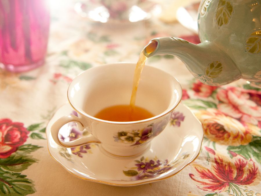 tea party pouring tea into a tea cup